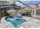Backyard pool area with screened enclosure overlooking the lake and ample patio seating at 15012 Maurine Cove Ln, Odessa, FL 33556