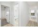 Hallway with tile flooring leading to bathroom and kitchen at 16039 Frost Dr, Hudson, FL 34667