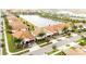 Overview of a residential neighborhood with waterfront homes, manicured lawns, and lush landscaping at 16831 Banner Shell Pl, Wimauma, FL 33598