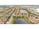 Aerial view of a community featuring well-maintained homes, lush landscaping, and scenic ponds at 16831 Banner Shell Pl, Wimauma, FL 33598