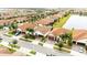 Aerial view of a neighborhood with well-maintained homes, green spaces, and a community lake at 16831 Banner Shell Pl, Wimauma, FL 33598
