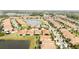 A picturesque aerial view showcasing a community with lush greenery, homes, and serene ponds at 16831 Banner Shell Pl, Wimauma, FL 33598