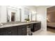 Stylish bathroom with double sinks, granite countertops, vanity and walk-in closet at 16831 Banner Shell Pl, Wimauma, FL 33598