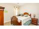 Well-lit bedroom with wood-look flooring, comfortable furnishings and decorative accents at 16831 Banner Shell Pl, Wimauma, FL 33598