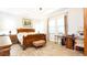 Well-appointed bedroom with wood flooring, a large bed, and a desk area, filled with natural light at 16831 Banner Shell Pl, Wimauma, FL 33598