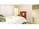 Bright bedroom with wood-look flooring, an open closet and an ensuite bathroom at 16831 Banner Shell Pl, Wimauma, FL 33598