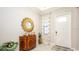 Inviting entryway featuring a decorative mirror, stylish console table, and tiled flooring at 16831 Banner Shell Pl, Wimauma, FL 33598
