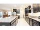 Spacious kitchen with black cabinets, stainless steel appliances, granite countertops, and an eat-in area at 16831 Banner Shell Pl, Wimauma, FL 33598