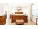 Bright main bedroom with a decorative bed frame, ensuite bathroom and neutral decor at 16831 Banner Shell Pl, Wimauma, FL 33598