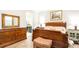 Comfortable main bedroom with wood-look flooring and ensuite bathroom at 16831 Banner Shell Pl, Wimauma, FL 33598