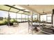Screened patio providing an outdoor living space, with views of the lake and the well-maintained backyard at 16831 Banner Shell Pl, Wimauma, FL 33598