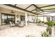 Spacious screened-in patio with seating, ceiling fans, and views of the expansive backyard at 16831 Banner Shell Pl, Wimauma, FL 33598