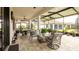 Comfortable screened patio with ample seating, ceiling fans, and views of the home's manicured backyard at 16831 Banner Shell Pl, Wimauma, FL 33598