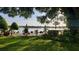 Expansive backyard with lush greenery, landscaping, and sparkling lake view at 1847 Shore Drive S # 415, South Pasadena, FL 33707