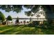 Scenic backyard with seating on the water, featuring lush greenery, mature shade trees, and serene lake views at 1847 Shore Drive S # 415, South Pasadena, FL 33707