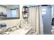 Bathroom featuring a glass sink, modern fixtures, and decorative shelves at 1847 Shore Drive S # 415, South Pasadena, FL 33707