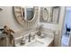 Bathroom featuring decorative mirrors, marble countertops, and stylish fixtures at 1847 Shore Drive S # 415, South Pasadena, FL 33707