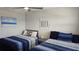 Bedroom featuring two twin beds, ceiling fan, and minimalist wall art at 1847 Shore Drive S # 415, South Pasadena, FL 33707