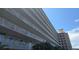 A view of the exterior of the condominium building showcasing multiple levels and balcony railings at 1847 Shore Drive S # 415, South Pasadena, FL 33707