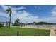 A well-kept outdoor community pool features a large grassy area, a palm tree, and lounge seating at 1847 Shore Drive S # 415, South Pasadena, FL 33707