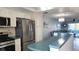 Modern kitchen featuring stainless steel appliances, light cabinets and a breakfast bar overlooking the living area at 1847 Shore Drive S # 415, South Pasadena, FL 33707
