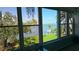 Bright living room with large windows offering serene water views and lush greenery at 1847 Shore Drive S # 415, South Pasadena, FL 33707