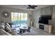 Living room featuring comfortable sofa, modern decor, scenic views and access to a sunny patio for relaxation at 1847 Shore Drive S # 415, South Pasadena, FL 33707