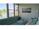 Relaxing sunroom featuring beautiful water views, comfortable seating, and ample natural light at 1847 Shore Drive S # 415, South Pasadena, FL 33707