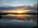 Reflective water view with the sun setting on the horizon, creating a peaceful ambiance at 1847 Shore Drive S # 415, South Pasadena, FL 33707