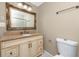 Bathroom featuring a vanity with granite countertop and decorative mirror at 1881 Lichen Ln # B, Clearwater, FL 33760