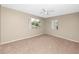Bedroom with carpet floors, neutral walls, ceiling fan and two windows at 1881 Lichen Ln # B, Clearwater, FL 33760