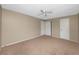 Bedroom with carpet floors, neutral walls, ceiling fan and a closet at 1881 Lichen Ln # B, Clearwater, FL 33760