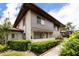 Condo exterior with lush landscaping and mature plants at 1881 Lichen Ln # B, Clearwater, FL 33760