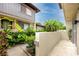 Exterior view of a condo with lush greenery, walkway, and private patio at 1881 Lichen Ln # B, Clearwater, FL 33760