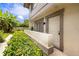 Exterior of a condo with a private entrance surrounded by lush landscaping and mature plants at 1881 Lichen Ln # B, Clearwater, FL 33760