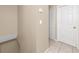 Hallway with tile floors, neutrally painted walls and a storage closet at 1881 Lichen Ln # B, Clearwater, FL 33760