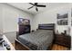 Comfortable bedroom with dark furniture and a ceiling fan at 19104 Cellini Pl, Lutz, FL 33558