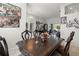 Open dining area with elegant decor, chandelier, decorative wall art, and views of the backyard at 19104 Cellini Pl, Lutz, FL 33558