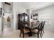 Formal dining room features a large wooden table with decorative china cabinet, and chandelier at 19104 Cellini Pl, Lutz, FL 33558