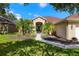 Inviting front entrance with lush landscaping, walkway, and double doors at 19104 Cellini Pl, Lutz, FL 33558