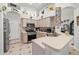 Bright kitchen featuring decorative shelves, updated appliances, tile floors, and ample counter space at 19104 Cellini Pl, Lutz, FL 33558