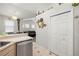 View of the kitchen featuring a stainless steel dishwasher and bi-fold pantry door at 19104 Cellini Pl, Lutz, FL 33558