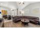 Open-concept living space with a round coffee table, leather sofa, and dining area at 19104 Cellini Pl, Lutz, FL 33558