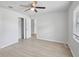 Bright bedroom featuring a ceiling fan, closet, and wood-look flooring for a modern and comfortable living space at 212 Gay Rd, Seffner, FL 33584