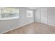Bright, airy bedroom with wood-look floors and natural light from two windows at 212 Gay Rd, Seffner, FL 33584