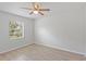 Bedroom featuring wood-look floors, modern fan, and natural light at 212 Gay Rd, Seffner, FL 33584