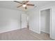 Spacious bedroom with light-colored walls, closet, and fan, perfect for comfort at 212 Gay Rd, Seffner, FL 33584