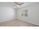 Bedroom featuring a ceiling fan, window, and new floors at 212 Gay Rd, Seffner, FL 33584