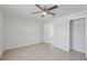 Comfortable bedroom with ceiling fan, closet, and light-colored walls at 212 Gay Rd, Seffner, FL 33584