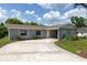Charming single-story home featuring a stone facade, well-maintained landscaping, and an expansive driveway at 212 Gay Rd, Seffner, FL 33584